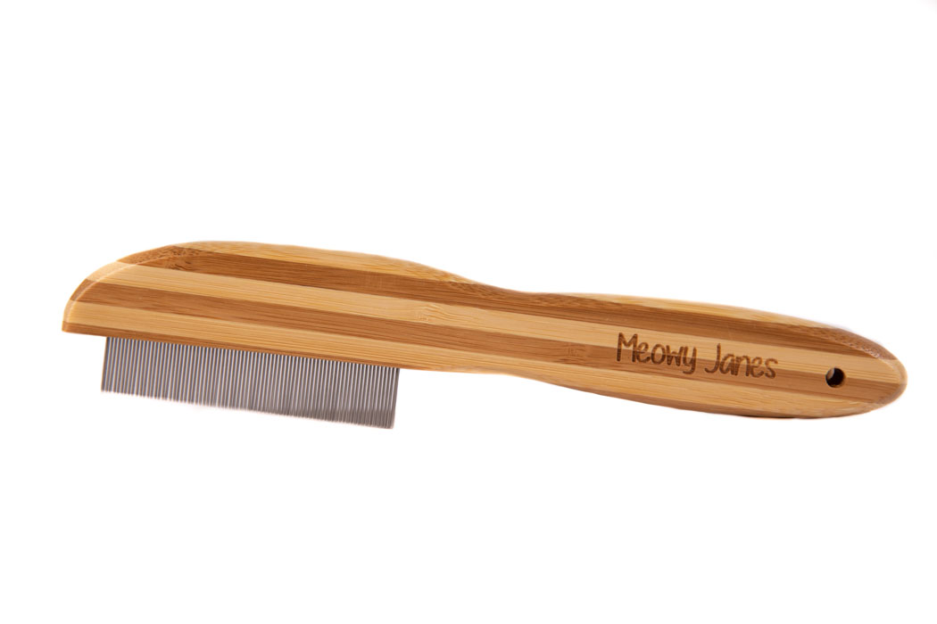 A flea comb with bamboo handle for cats