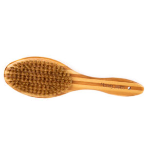 A boar hair brush with bamboo handle for cats