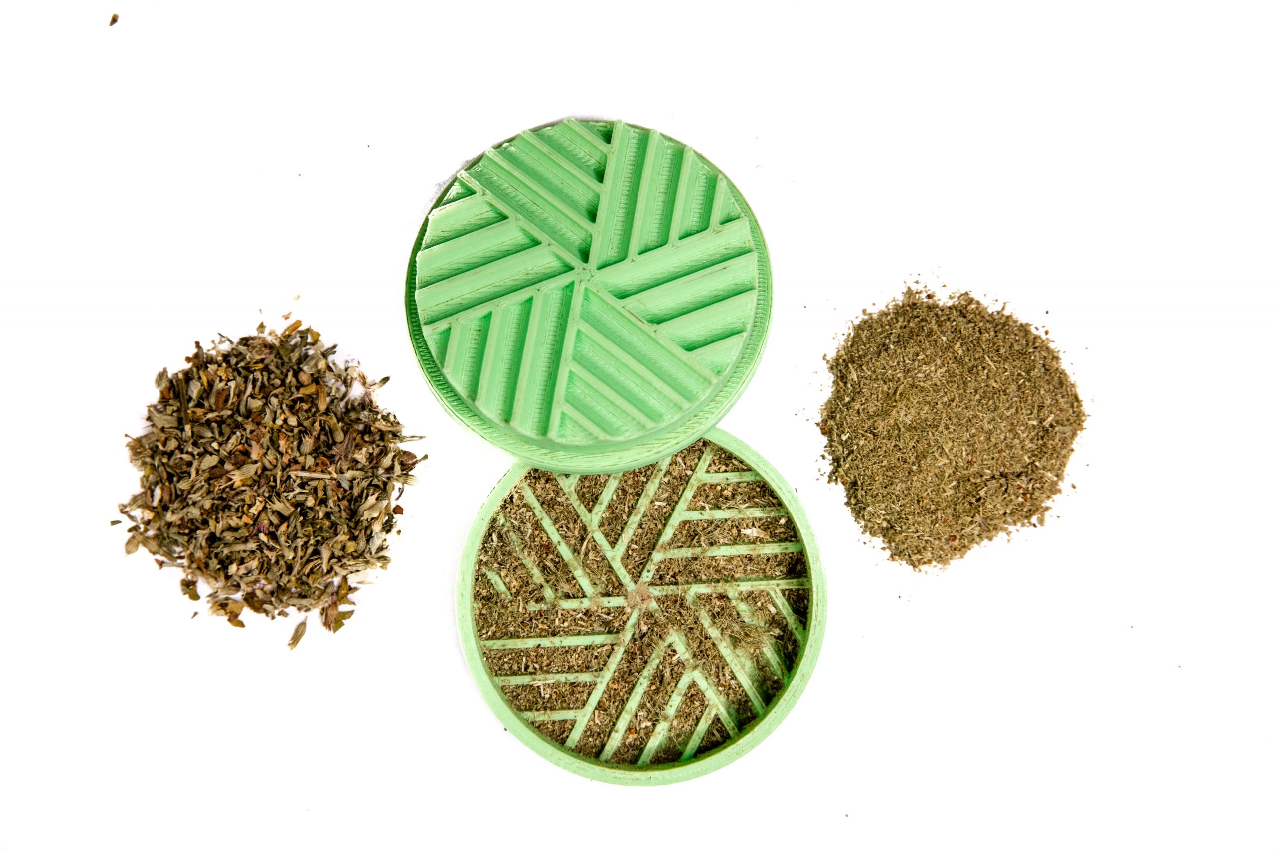 A green plastic 3d printed grinder for catnip with catnip