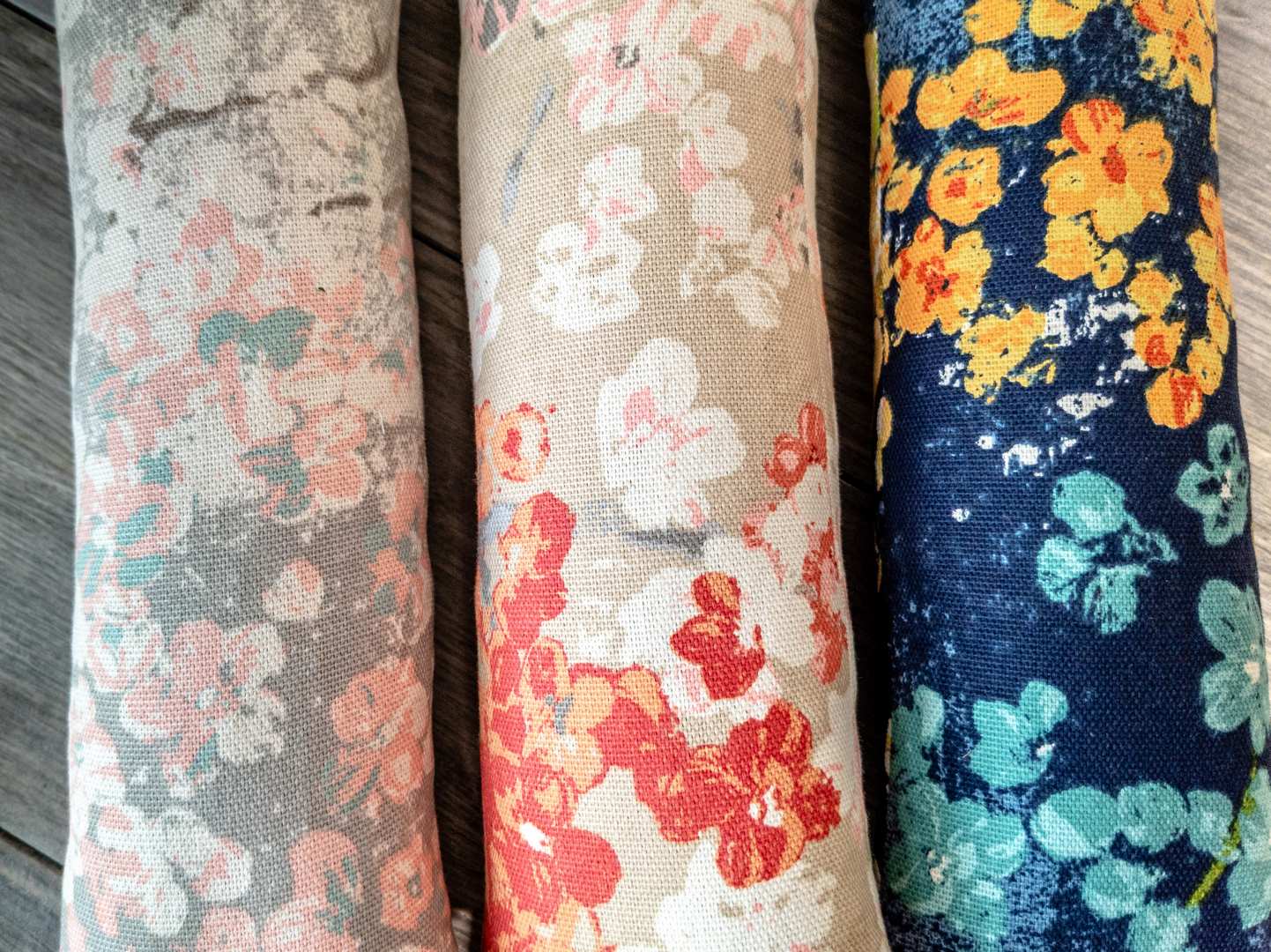 Multiple catnip kicker cat toys made out of a fabric with various prints that look like Japanese cherry blossoms