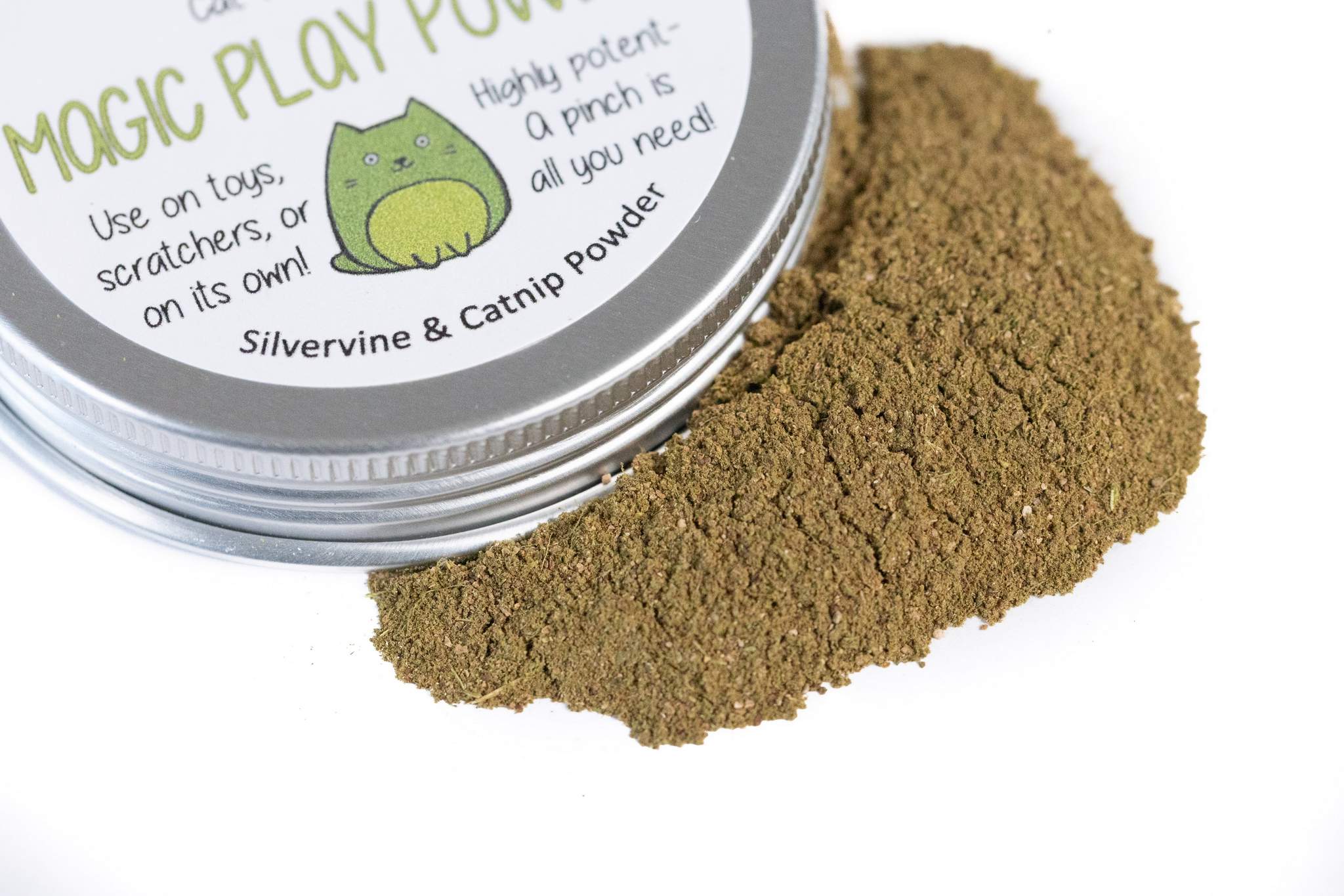 A tin near a pile of brown magic play powder