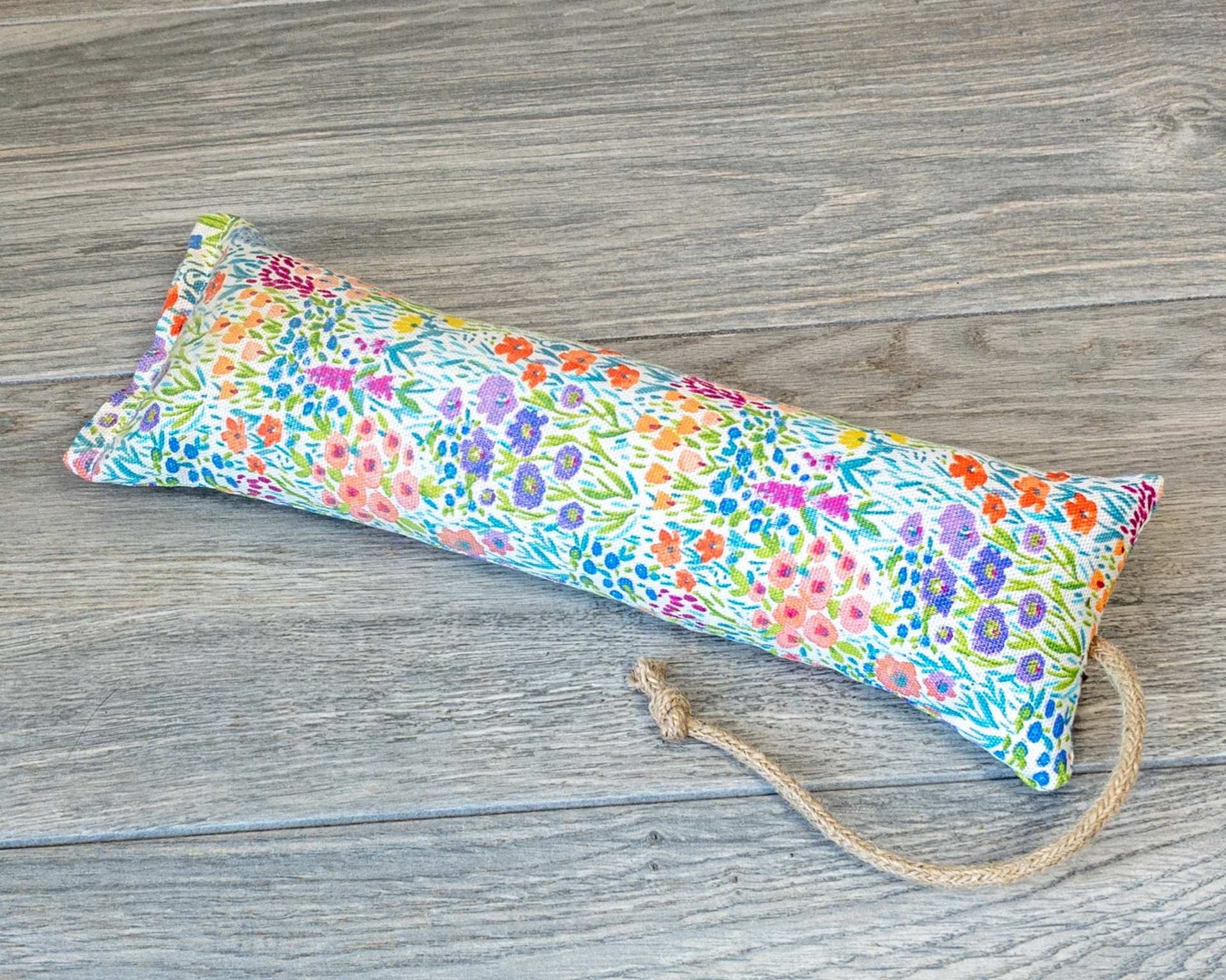 A catnip kicker made from a watercolor wildflower themed fabric