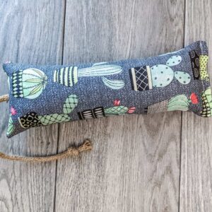 A catnip kicker made from a grey fabric with cactus prints on it.