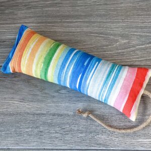 A catnip kicker made out of a fabric that looks like a watercolor rainbow stuffed with catnip