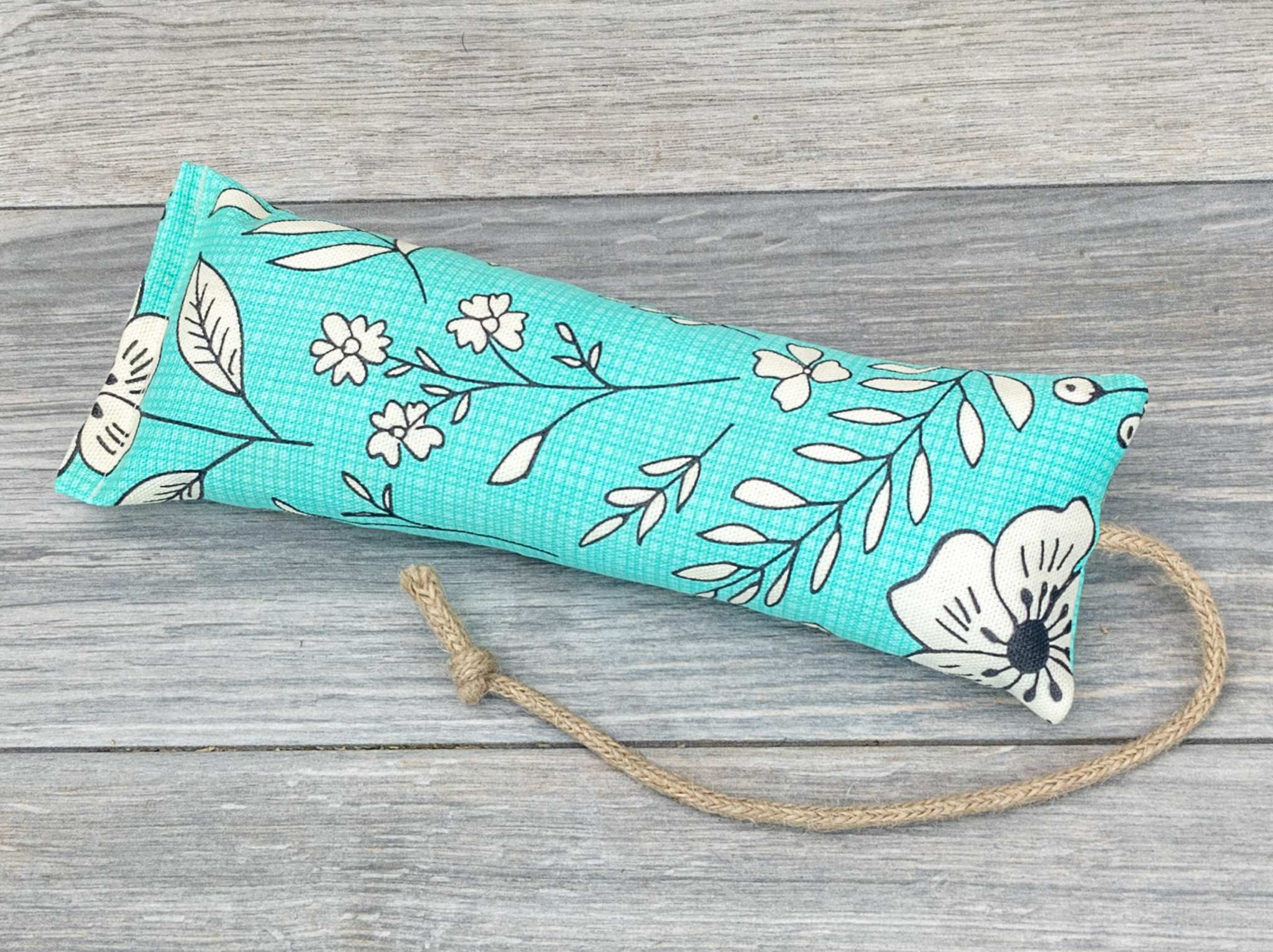 A catnip kicker made from a fabric with a green modern pop art flower print