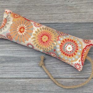 A catnip kicker made from a fabric with orange flower print.