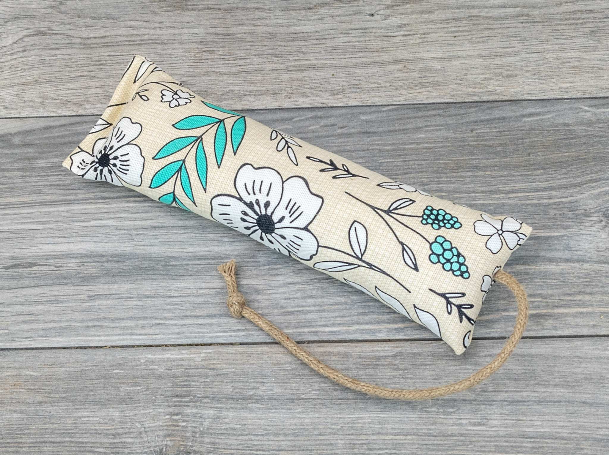 A catnip kicker made from a fabric with a white modern pop art flower print