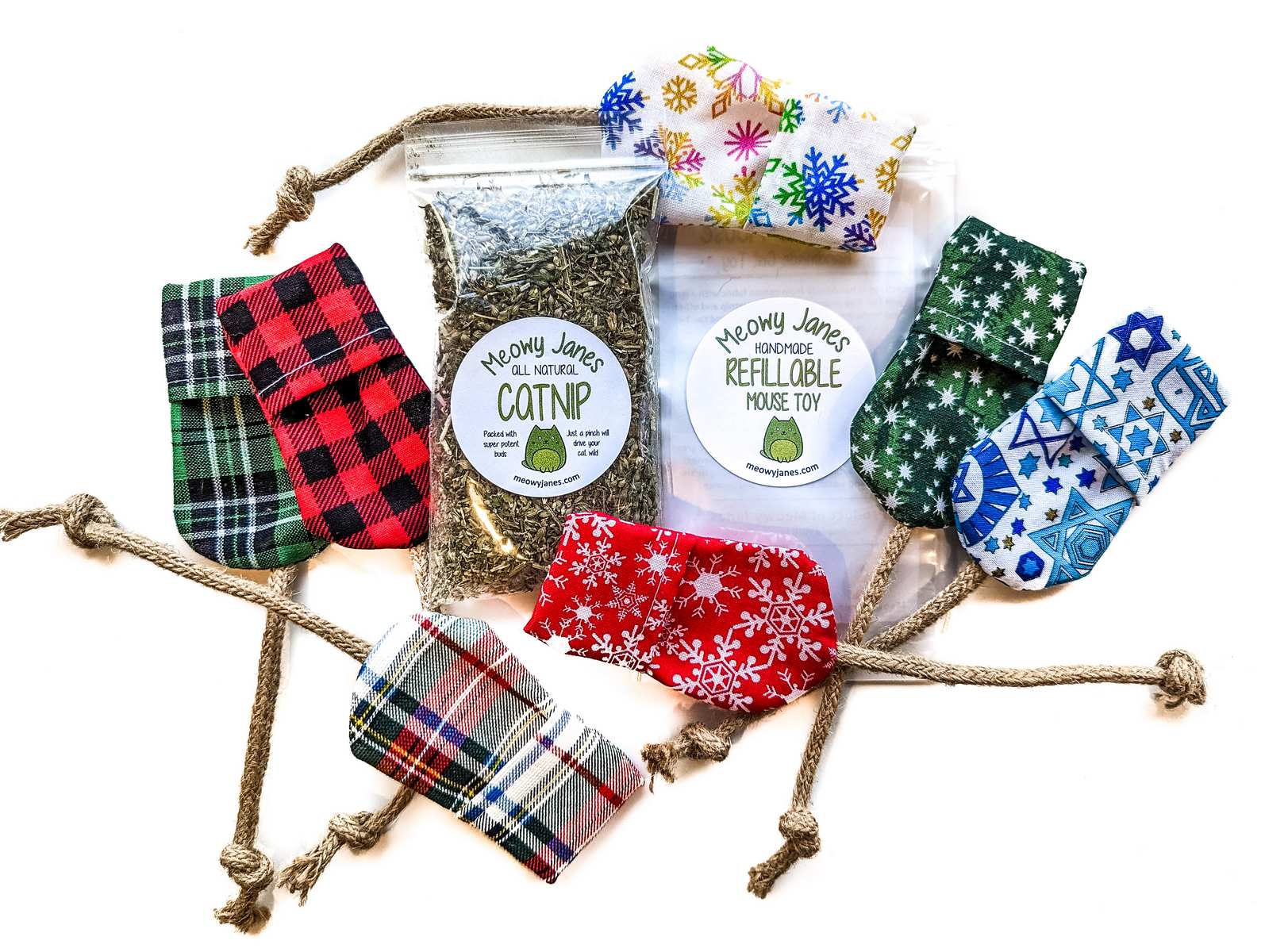 Fabric mouse toys in various holiday print fabrics with a bag of catnip