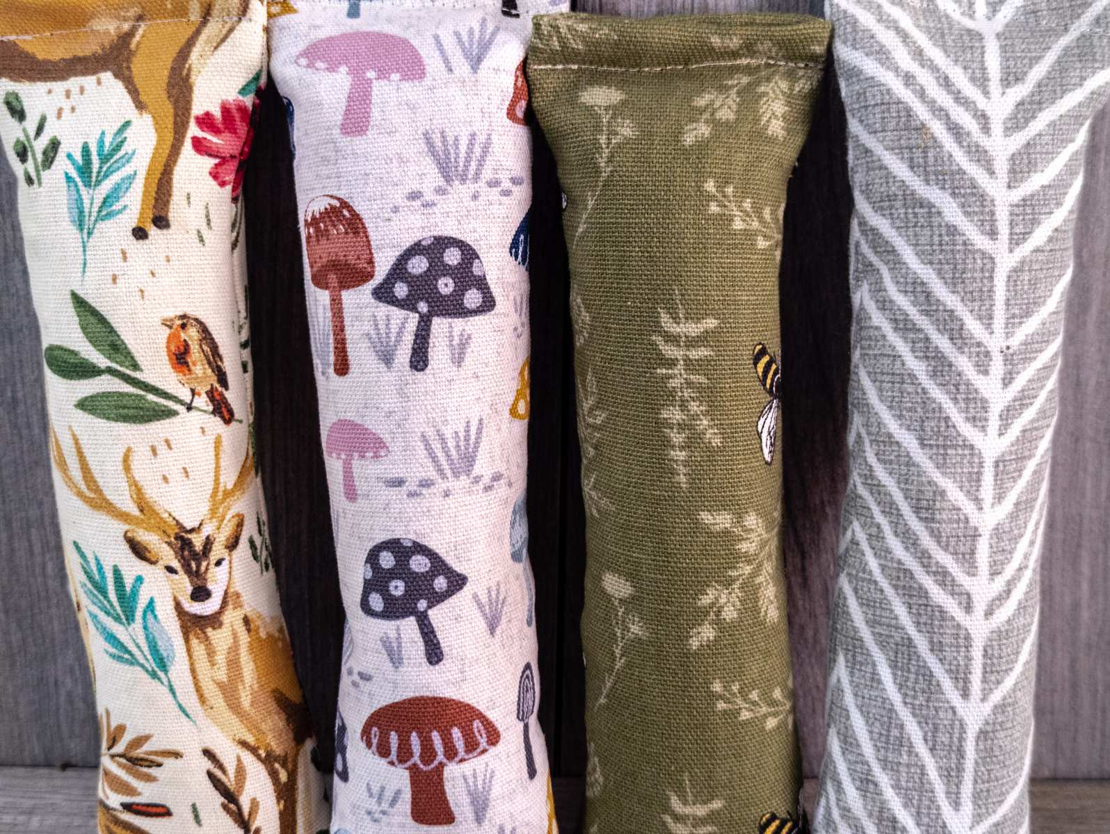 Multiple catnip kicker cat toys made out of a fabric with various prints