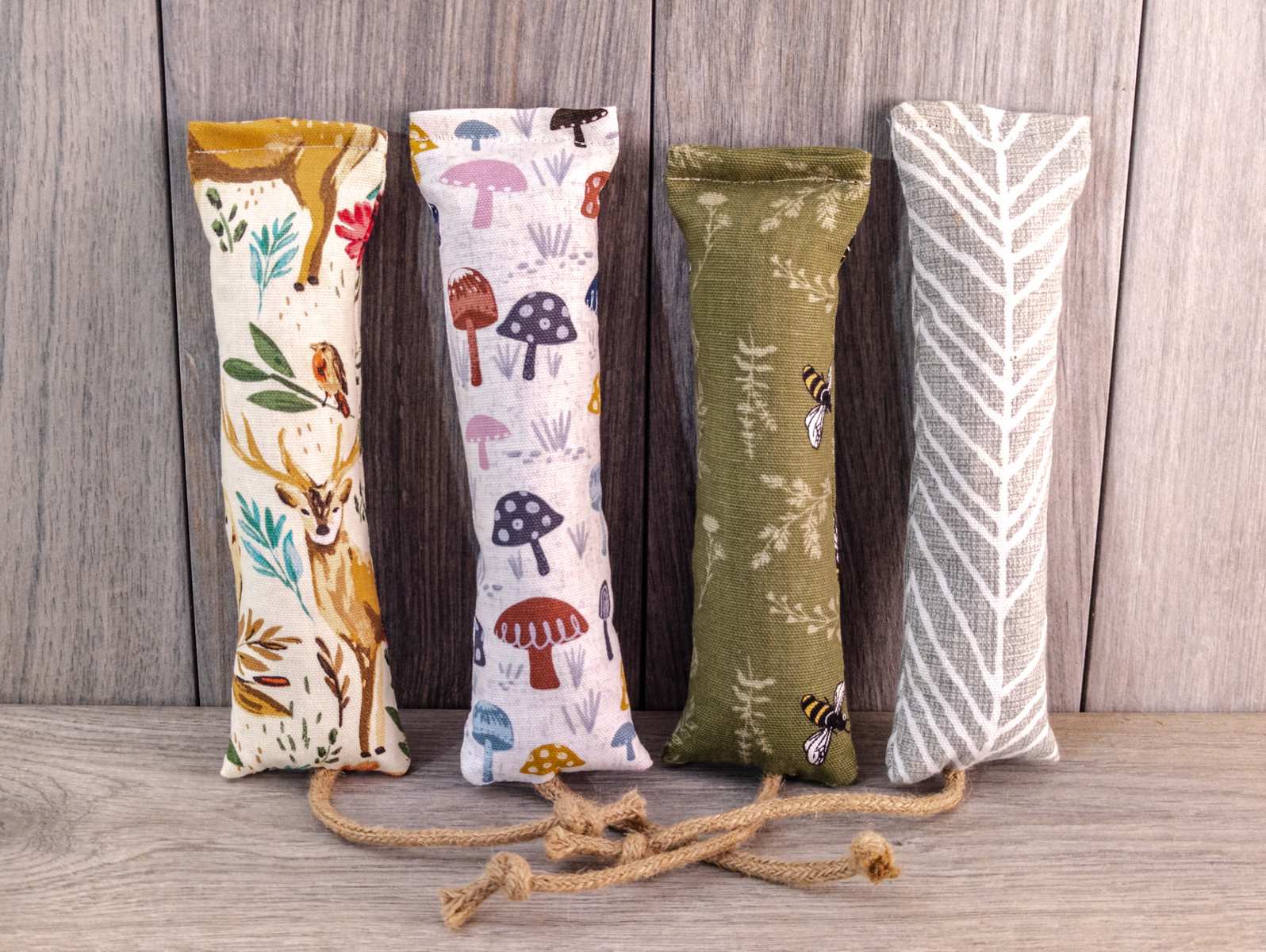 Multiple catnip kicker cat toys made out of a fabric with various prints