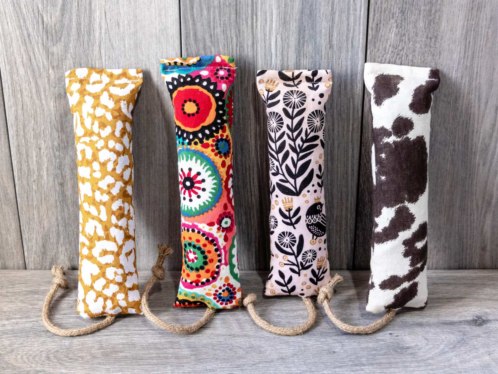 Four catnip kicker cat toys made out of various fabric prints