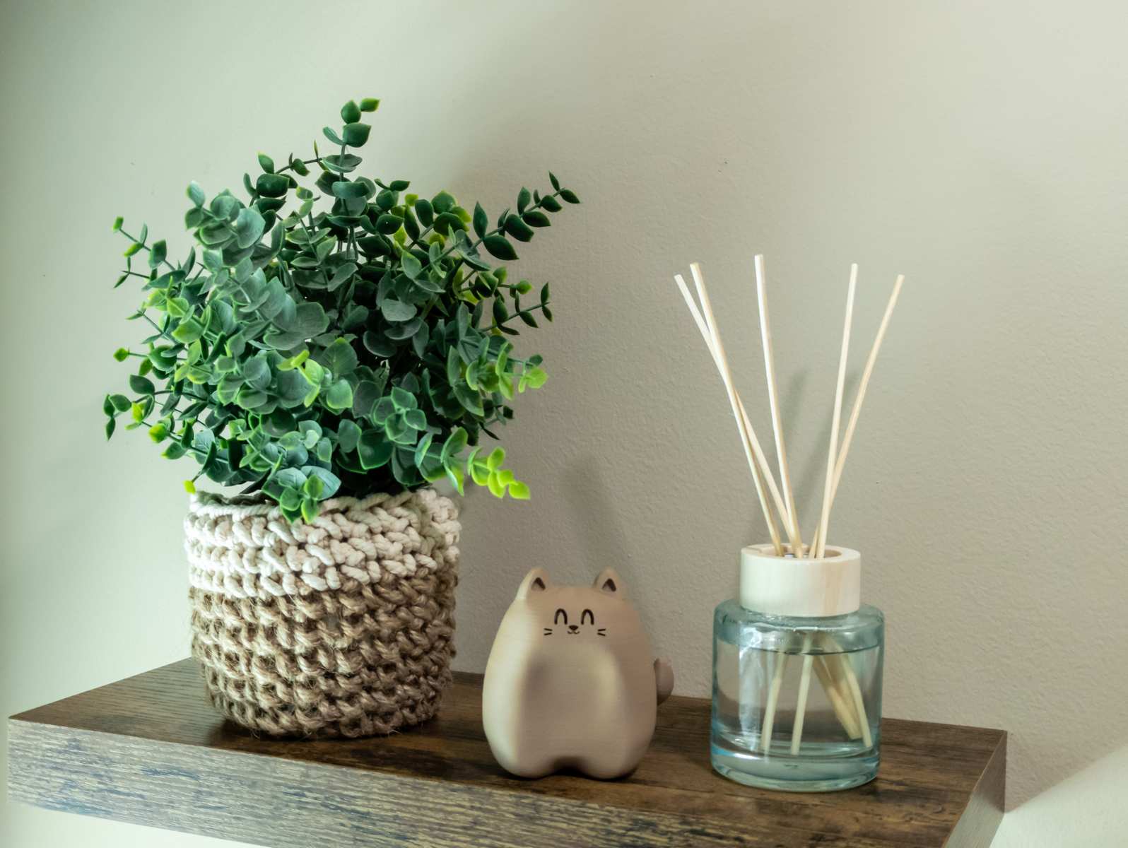A wooden looking cat figure on a shelf