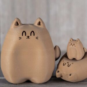 Various sizes of figures of 3D printed cats that looks like wood