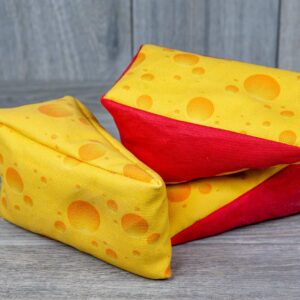 A stuffed toy shaped like a cheese made out of a fabric that looks like cheese
