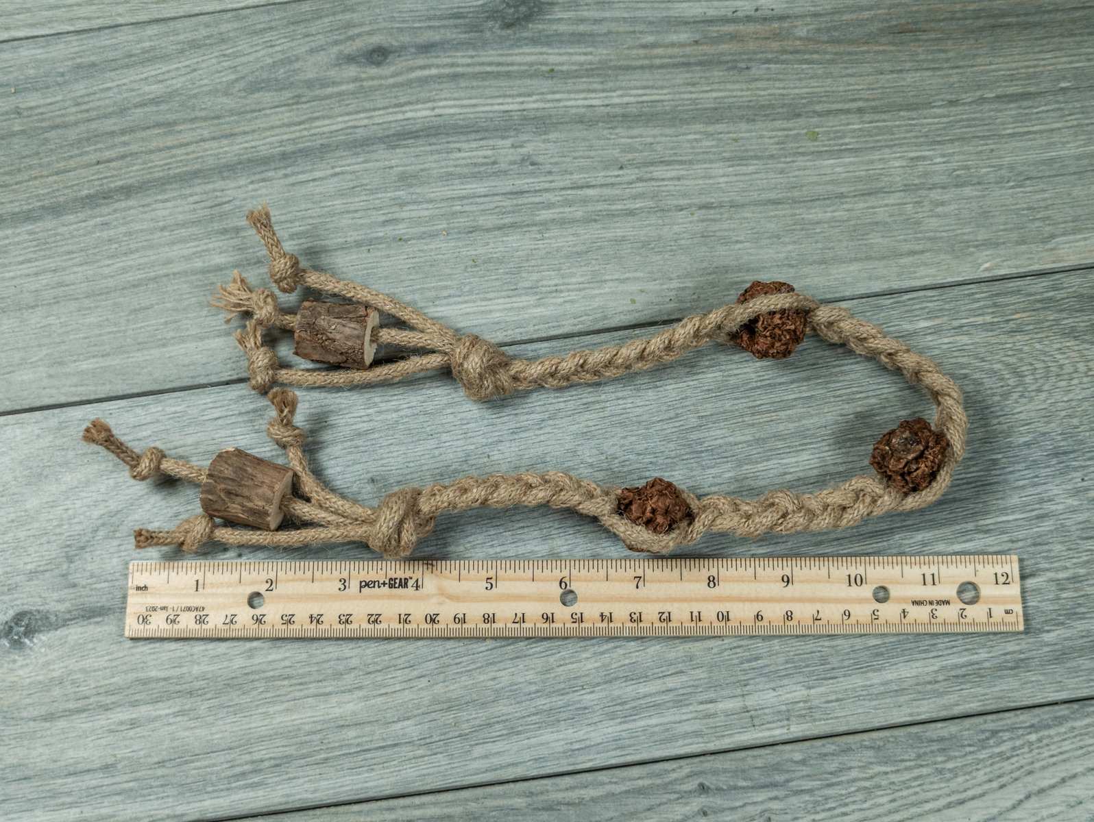 A braided jute rope with silvervine fruits threaded onto it