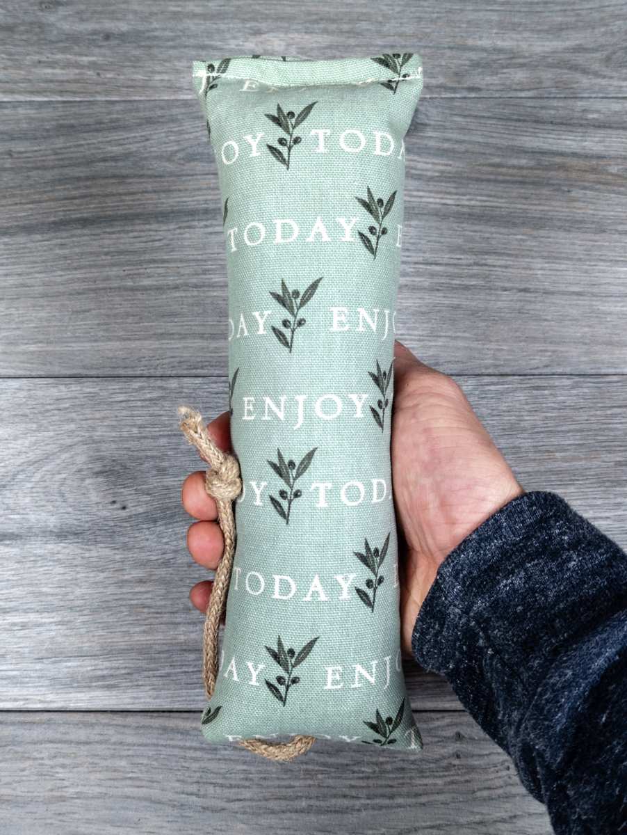 A catnip kicker made of fabric that says "Enjoy Today" on it.