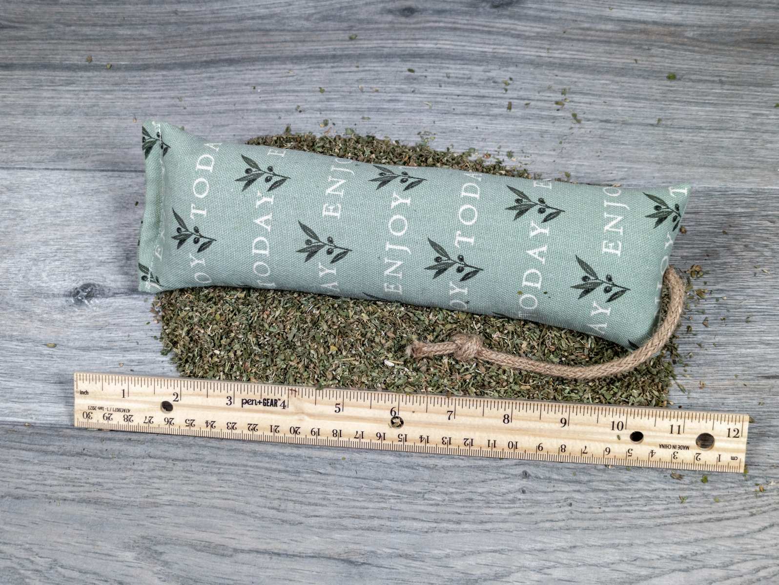 A catnip kicker made of fabric that says "Enjoy Today" on it.