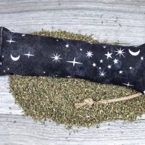 A catnip kicker made of a black fabric with white stars on it