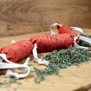 A sausage made of fabric stuffed with catnip to be used as a cat toy