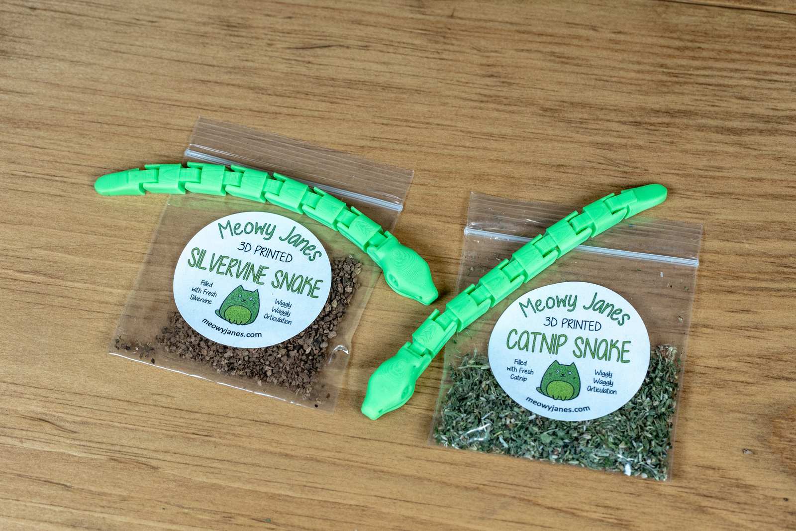 Green articulated snake toys with smalls bags of catnip and silvervine