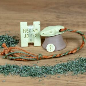 A 3D printed Snake toy for cats with various accessories and pile of catnip