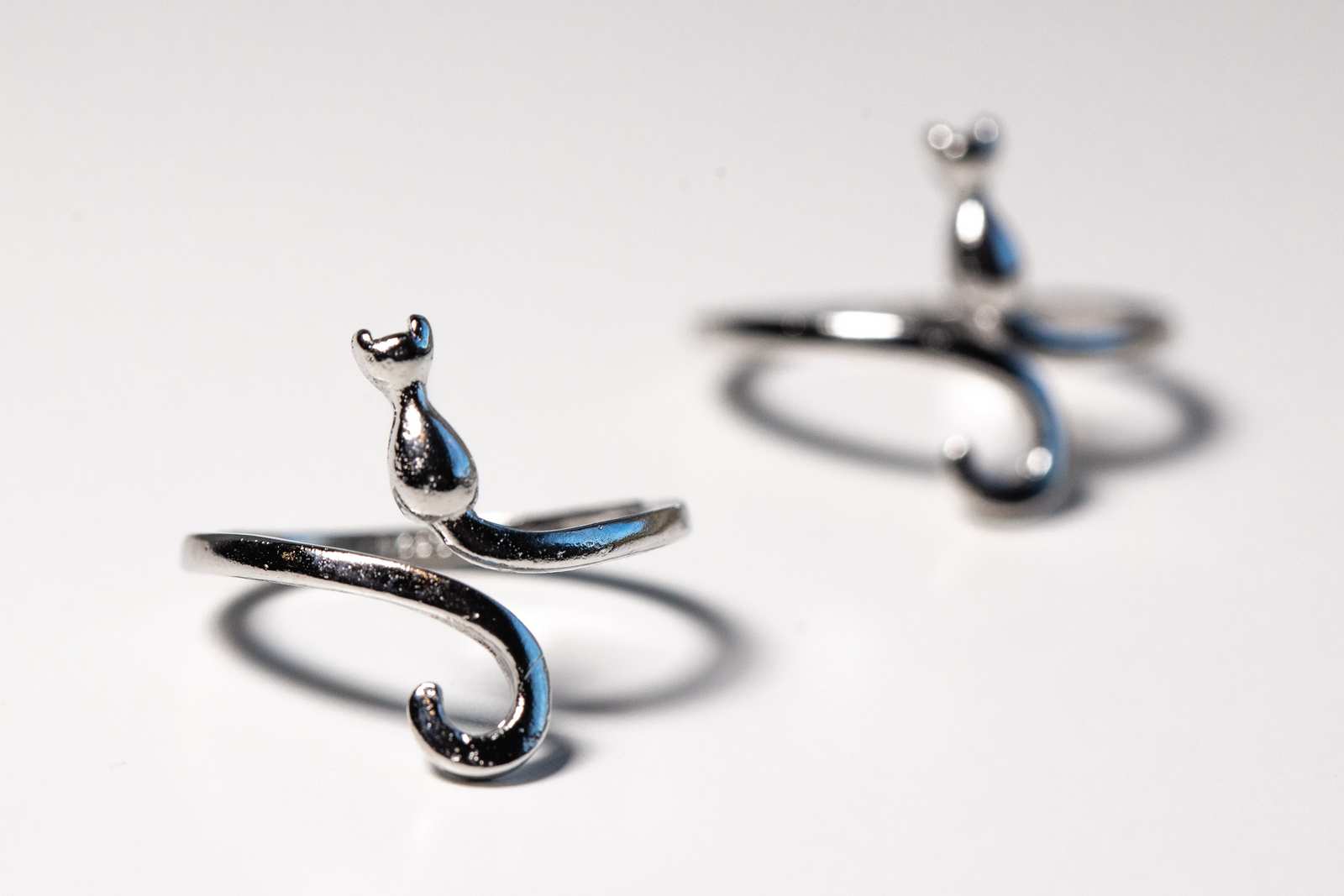 Two metal rings that look like cats