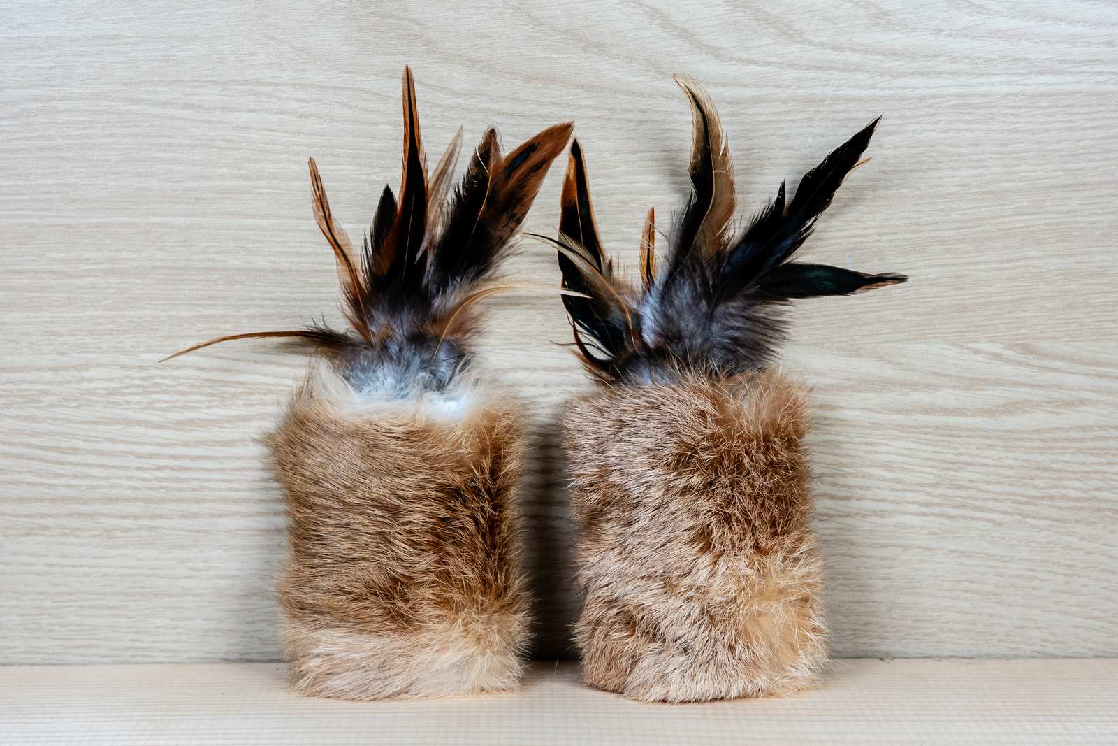 Two rectangular cat toys made of rabbit fur and feathers
