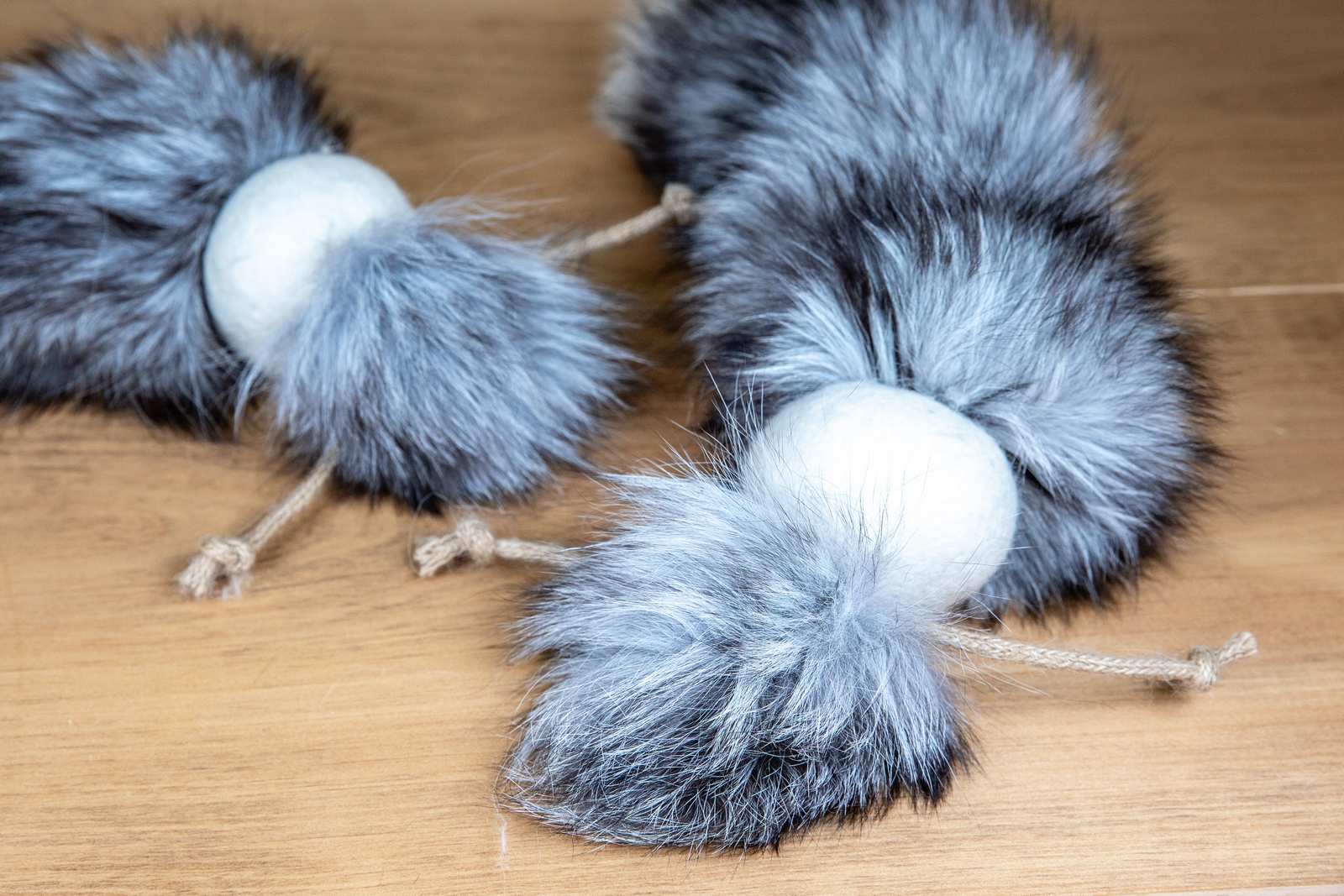 Showing the detail of cat toys made out of a fox tail attached to a wool ball