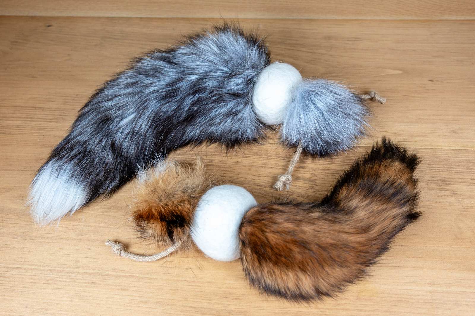 Cat toys made out of a fox tail attached to a wool ball