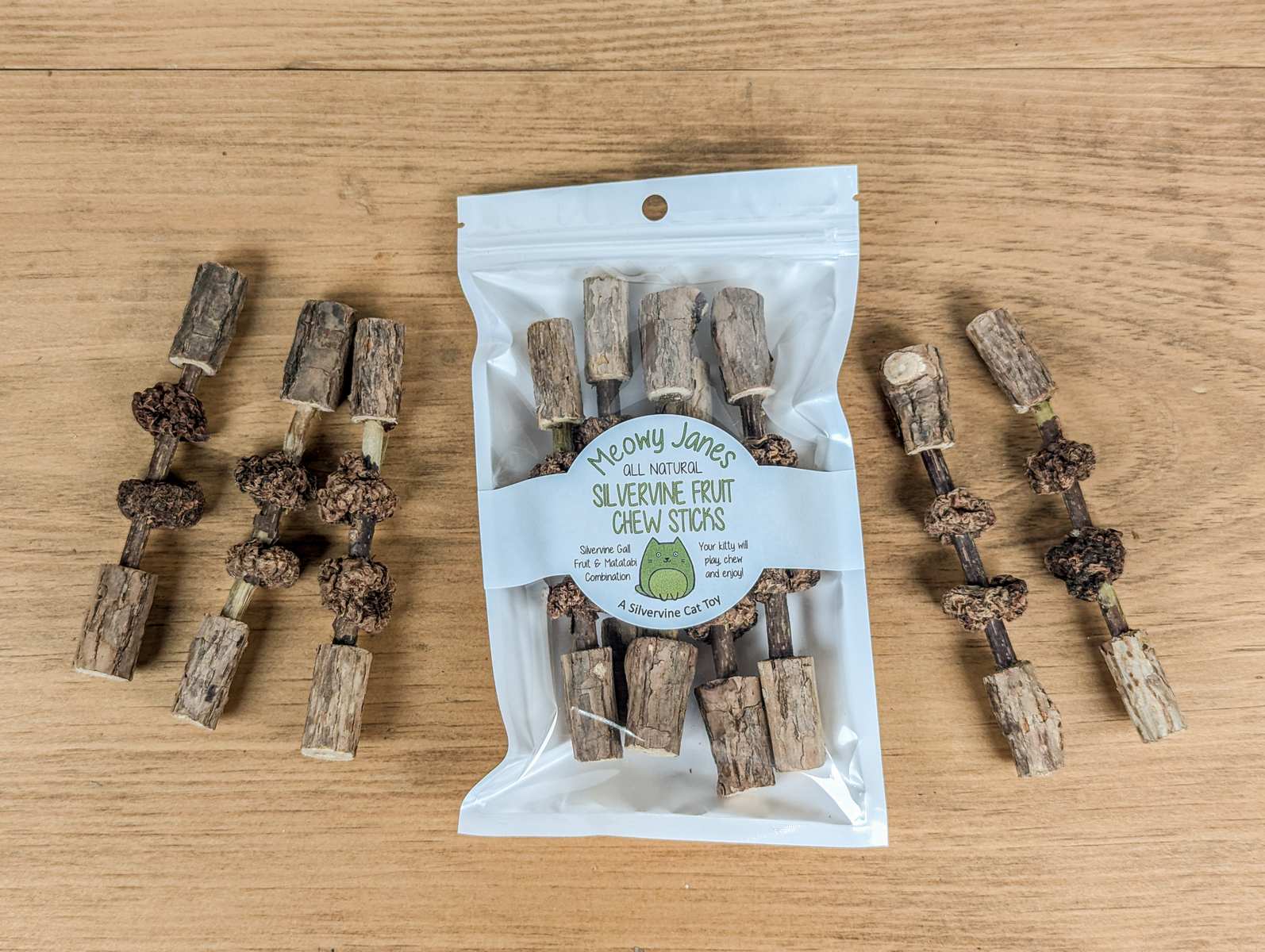 Matatabi sticks with silvervine fruits and matatabi stick end caps attached.