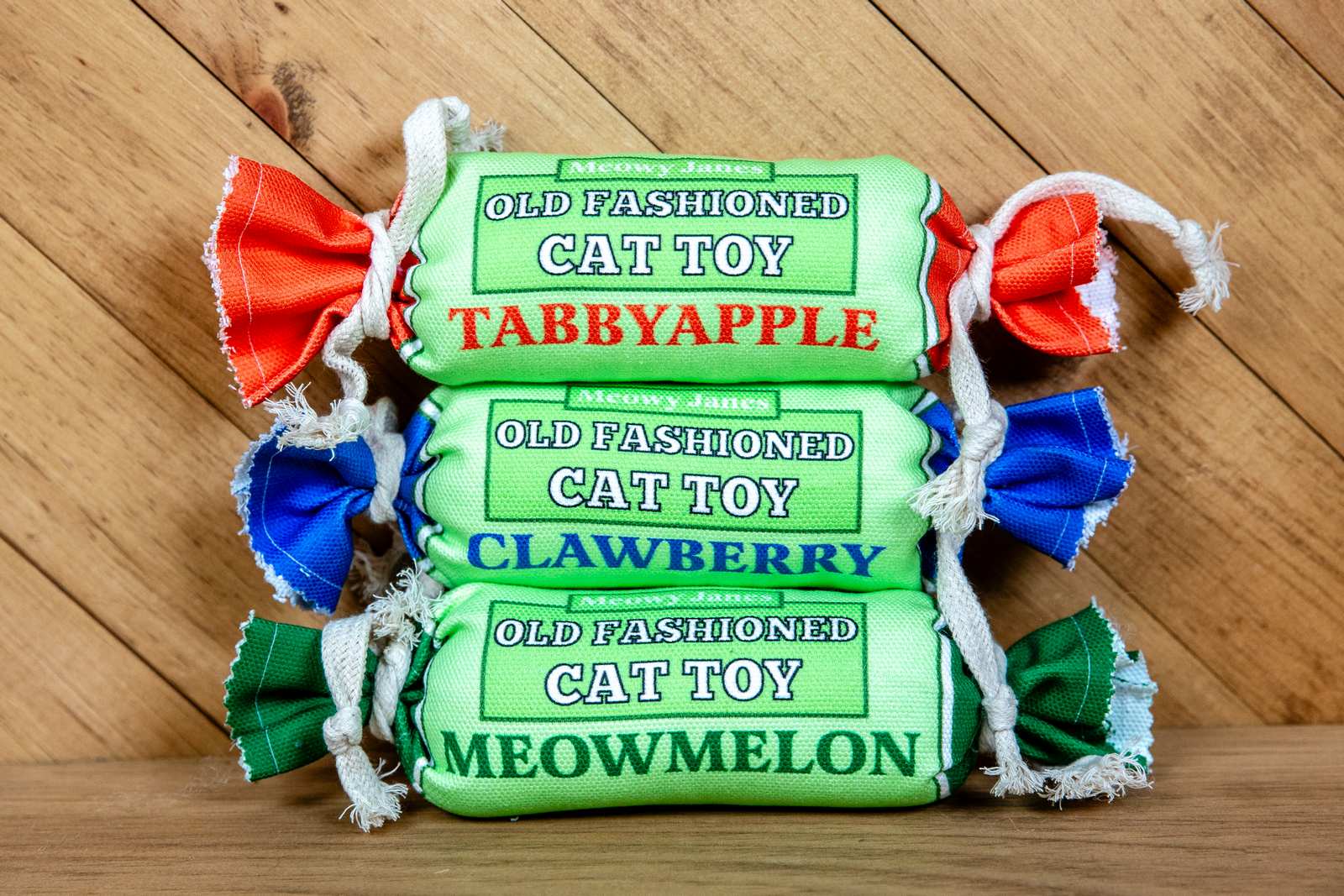 Three penny candy cat toys in different colors; blue, red and green