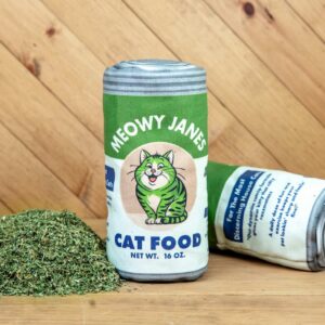 A sewn toy that looks like a can of cat food next to a pile of catnip