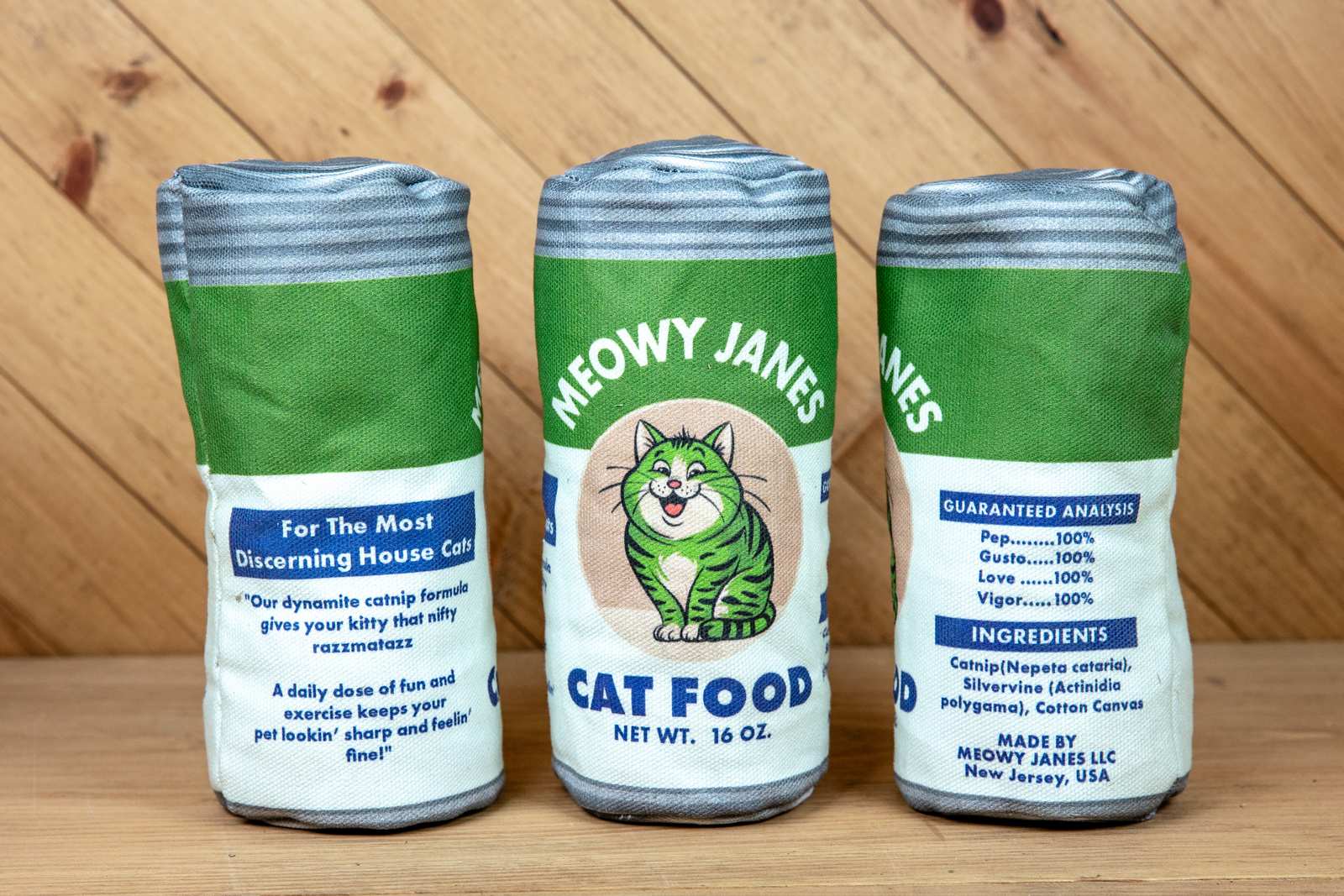 A sewn toy that looks like a can of cat food from 3 different angles