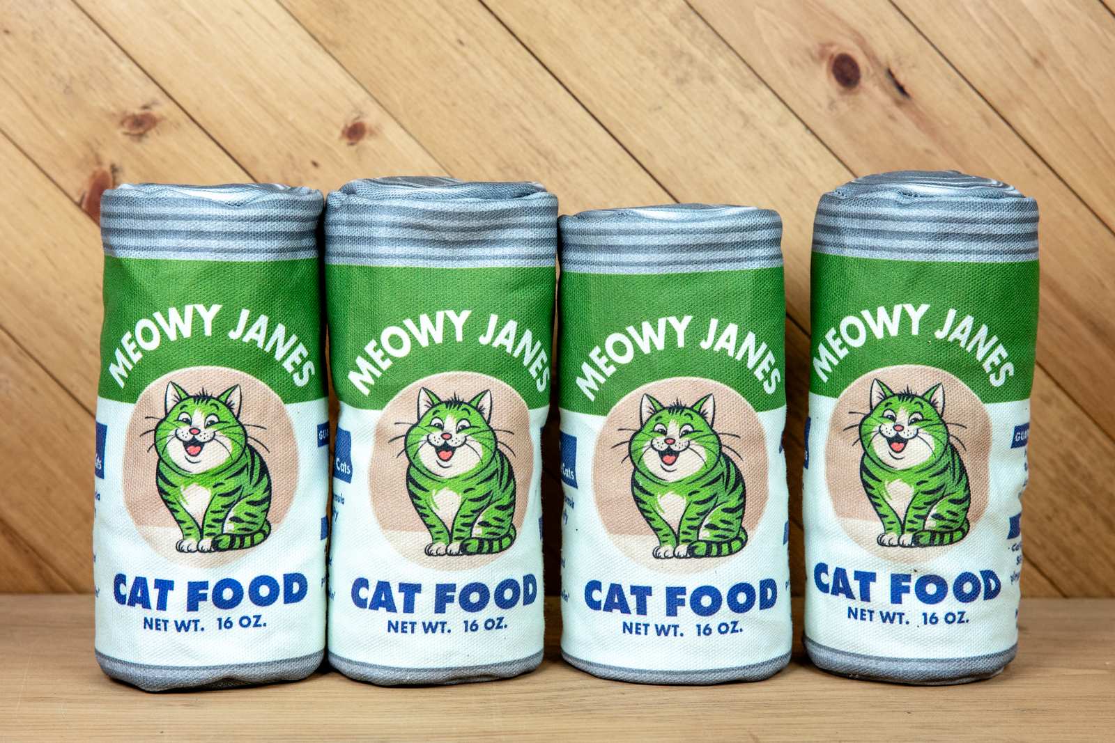 4 sewn toys that look like cans of catnip in a line