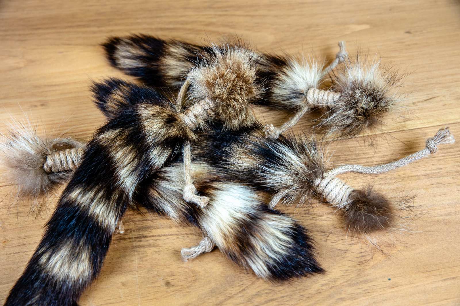 A pile of raccoon tails with jute rope tied around them.
